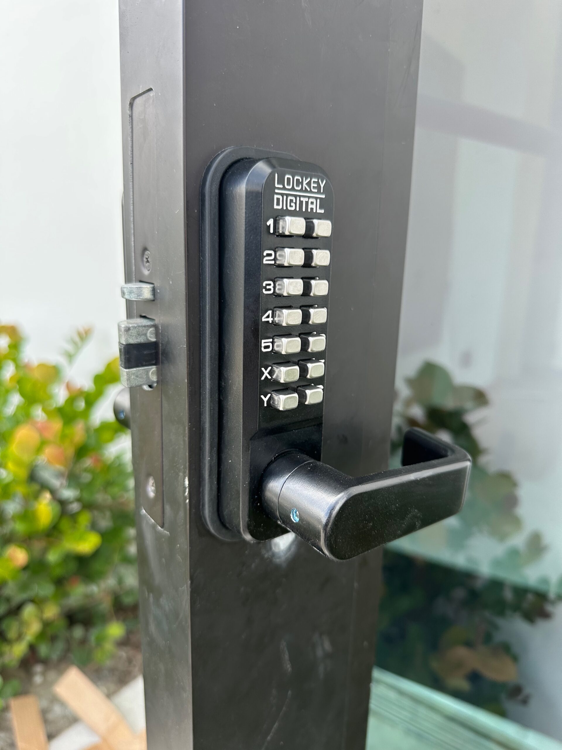 Mechanical push-button keyless lock installed on a gate in Brevard County